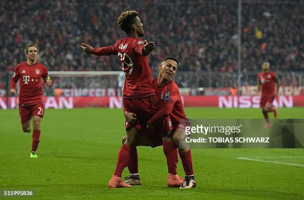 Bayern Munich's French defender Kingsley Coman reacts after scoring with Spanish midfielder Thiago Alcantara during extra-time during the UEFA...
