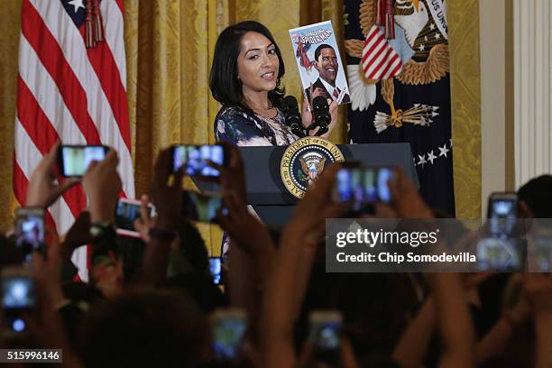 Marvel comic book creator and editor Sana Amanat holds up a comic book featuring U.S. President Barack Obama as she introduces him at a reception for...