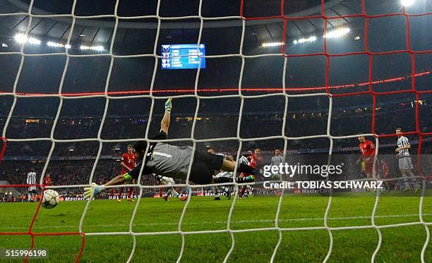 Juventus' goalkeeper from Italy Gianluigi Buffon misses a shot from Spanish midfielder Thiago Alcantara during extra-time during the UEFA Champions...