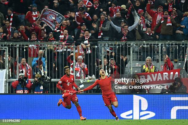 Bayern Munich's French defender Kingsley Coman and Bayern Munich's Spanish midfielder Thiago Alcantara celebrate victory at the end of the extra time...