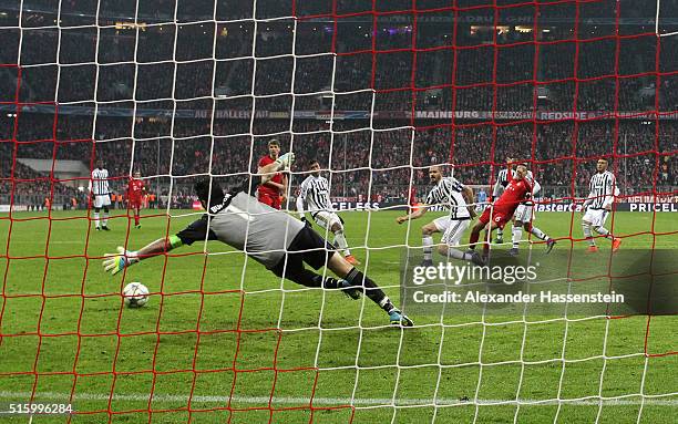 Thiago Alcantara of Bayern Muenchen scores his team's third goal past Gianluigi Buffon of Juventus during the UEFA Champions League round of 16,...
