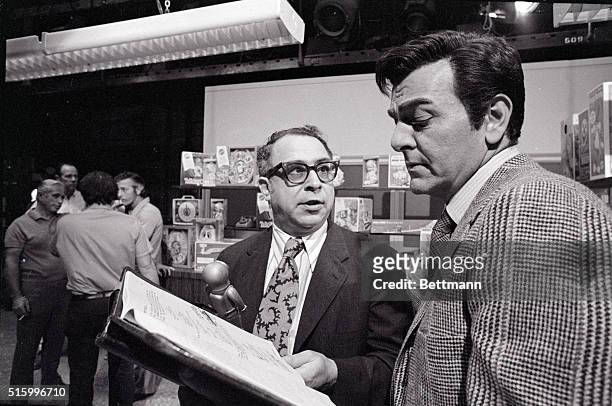 Hollywood, California- Humorist Art Buchwald goes over his lines with Mike Connors, star of the TV series, "Mannix." In making his dramatic acting...