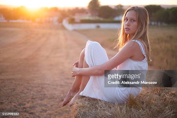 teenager girl in the field by the stack of hay - stack of sun lounges stock pictures, royalty-free photos & images