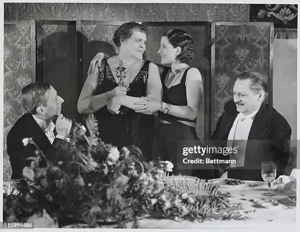 Marie Dressler Triumphs: Norma Shearer, last year's winner, presents Marie Dressler with the Statuette, awarded by the Academy of Motion Pictures...