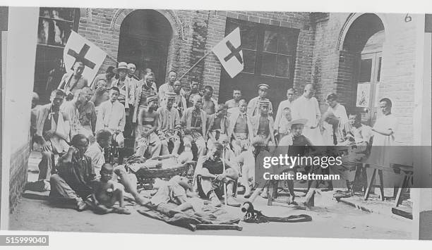China: Caring For China's War And Famine Victims! Photo shows famine victims and wounded soldiers being cared for by Chinese Red Cross. The American...