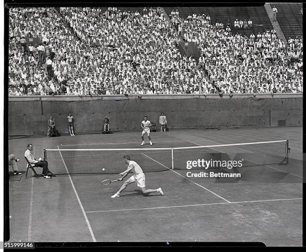 Forest Hills, NY: Australian Champion Frank Sedgman prepares to make a backhand return to Ted Schroeder of La Sescenta, CA., during their Davis Cup...