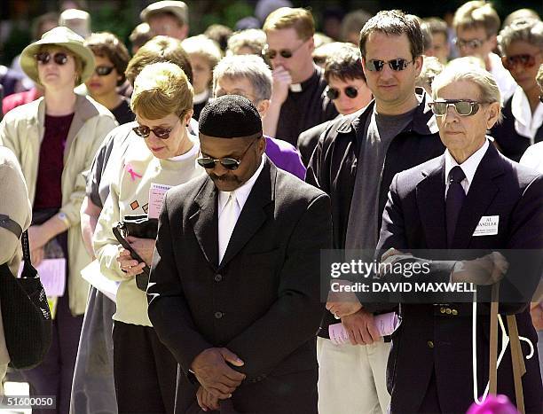 Community members gather at Fountain Square to pray for peace on 13 April, 2001 in downtown Cincinnati, Ohio. Cincinnati city officials heaved a sigh...