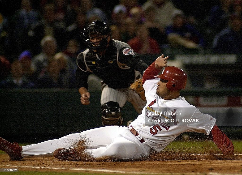 St. Louis Cardinals' Albert Pujols slides home saf