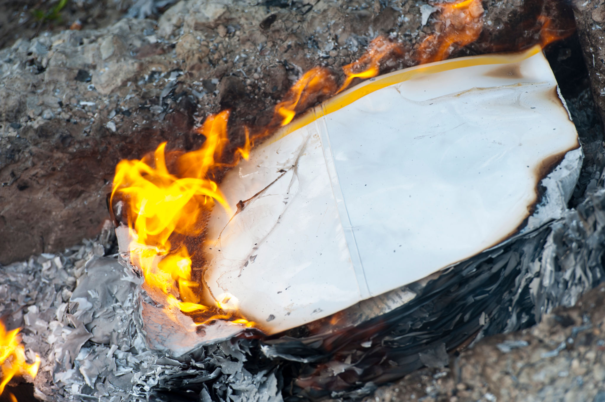 Burning office white paper in bonfire Burning office white paper in bonfire