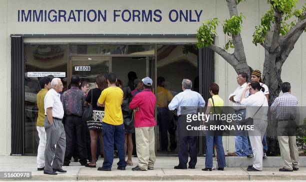Line forms near the entrance of the Immigration and Naturalization Service office in Miami, 30 April 2001, as the midnight deadline approaches for...