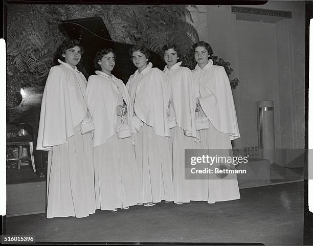 The Dionne Quints are shown here at the Waldorf-Astoria's Jade Room Preparatory for staging a singing rehearsal for the Alfred E. Smith Foundation...