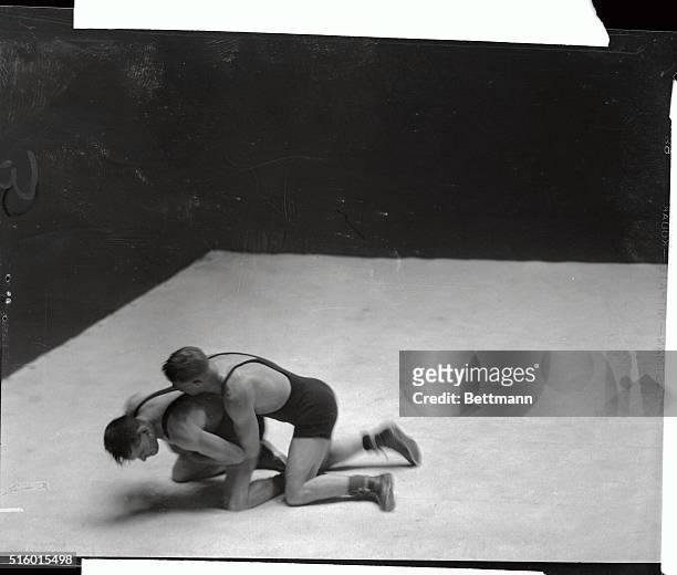 Einar Karlsson of Sweden and Taylor of Great Britain mix things up for their featherweight wrestling here. The match was won by Karlsson in the Los...