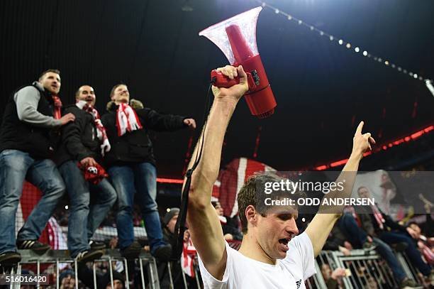 Bayern Munich's midfielder Thomas Mueller celebrates win fans after the UEFA Champions League, Round of 16, second leg football match FC Bayern...