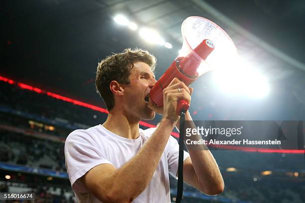 Thomas Muller of Bayern Muenchen applauds home supporters after his team's 4-2 win in the UEFA Champions League round of 16, second Leg match between...