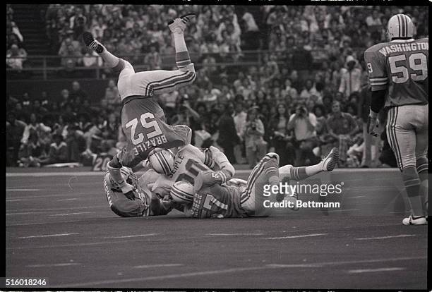 The rookie linebacker for the Houston Oilers, Robert Brazile, #52, goes head over heels during the 2nd quarter of a game on October 16th, 1975....
