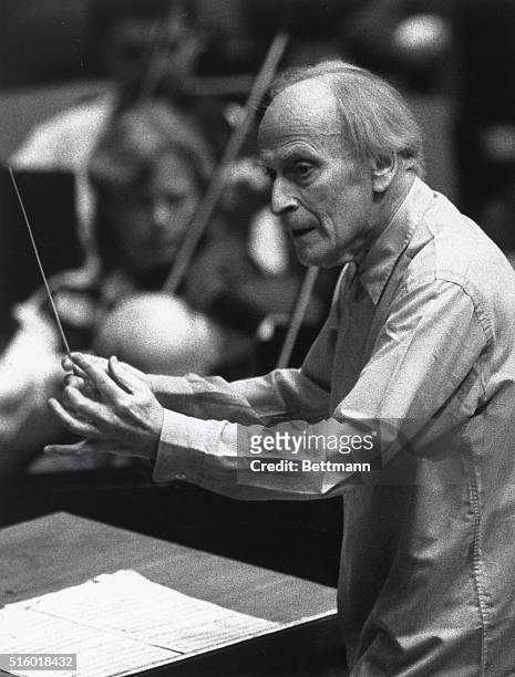 Yehudi Menuhin rehearses at the podium for a concert celebrating the 60th birthday of Mstislav Rostropovich, the director of the National Symphony.