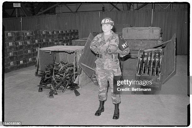 Weapons, including AK-47 rifles, captured by US troops during the Grenada Invasion are guarded by PFC Francine Benedict at Andrews Air Force Base in...