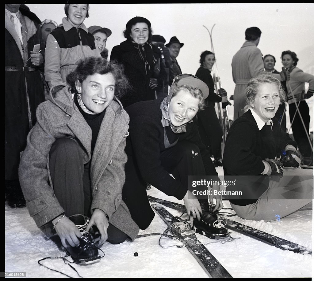 Athletes Adjusting Their Skis