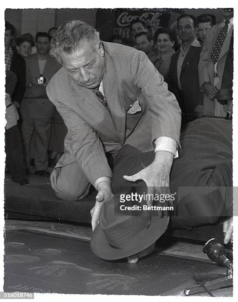 Hollywood, California: Opera and screen star Ezio Panza shoves Jimmy Durante's nose into wet concrete at Hollywood's Grauman's Chinese Theater, as...