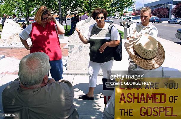 Allison Smith , former wife of polygamist Tom Green, and Andrea Ryan former wife of Green's stepson, argue with two Green's supporters outside 4th...