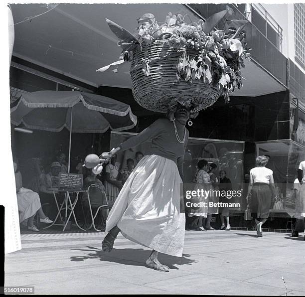 Port of Spain, Trinidad: Easter Bonnet? It's a practical "straw" worn by a native woman who really uses her head in business. She's toting real and...