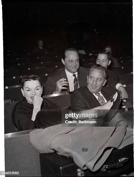 London, England: Actress Judy Garland appears pensive as she and musical director Gordon Jenkins attend, Oct. 15, a rehearsal for the Judy Garland...