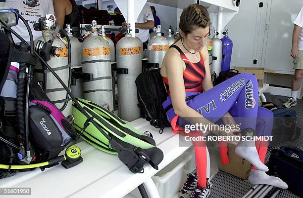 Frenchwoman Audrey Mestre Ferreras adjusts a diving watch to her ankle as she prepares to join her husband Pipin Ferreras to set the first record in...