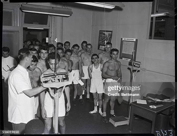 Pre-induction physicals. Photo shows group of young men taking their pre-induction physicals for the Army and the Marines.