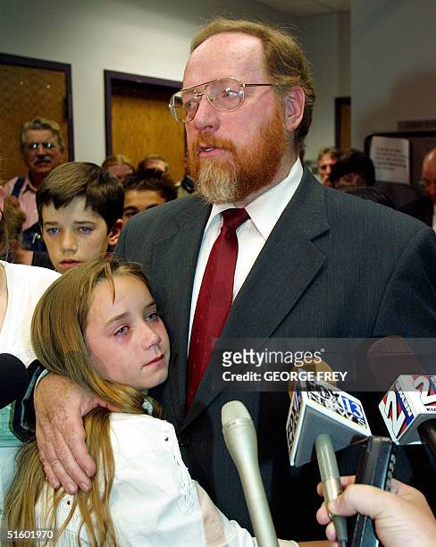 With tears rolling down her cheek, Sierra Green holds on to her father, Utah polygamist Tom Green , as he talks to reporters after he was convicted...