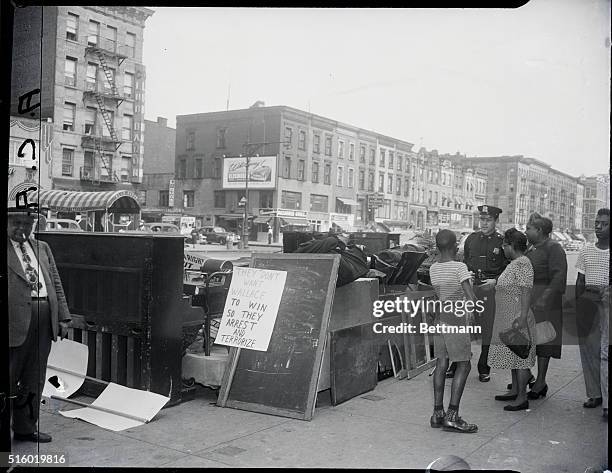 New York, NY: Wallace-Communist Part Headquarters disposed from 432 Lenox Avenue, in Harlem, City Marshal men remove furniture and other belongings...