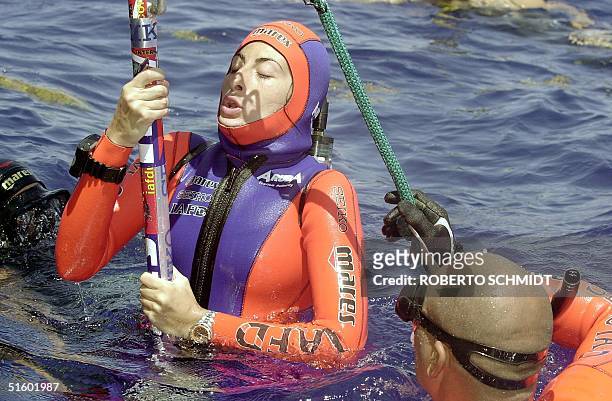 French diver Audrey Mestre Ferreras takes a last deep breath as she is assisted by her husband and freediving master Pipin before she succesfully...