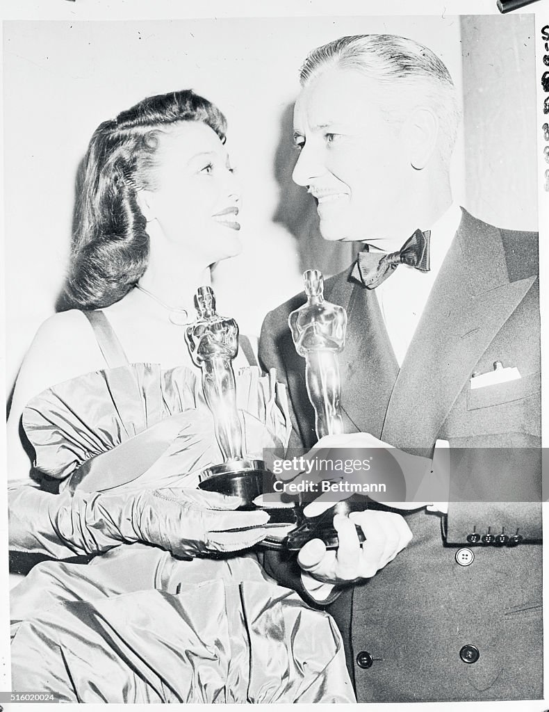 Loretta Young and Ronald Coleman Holding Oscars