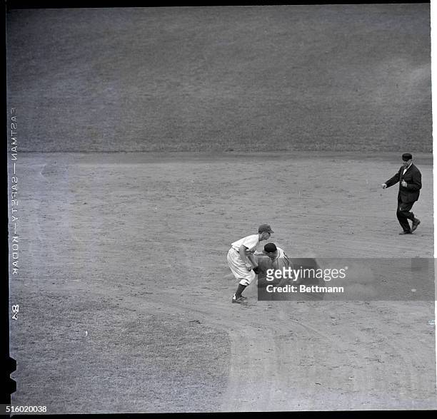 Don Padgett of the St. Louis Cardinals slides into second base. Pee Wee Reese waits for the ball but is too late to tag out Padgett.