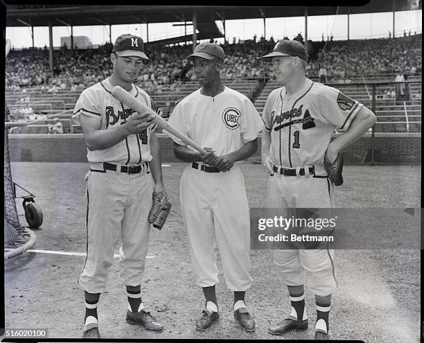 Eddie Mathews and Del Crandall , both of the Milwaukee Braves, check out the bat of Chicago Cubs star shortstop Ernie Banks . All three were chosen...