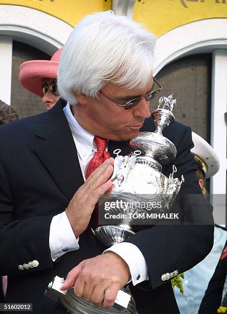 Trainer of Point Given, Bob Baffert, kisses the Woodlawn Vase trophy after Point Given won the 126th running of the Preakness Stakes at Pimlico Race...