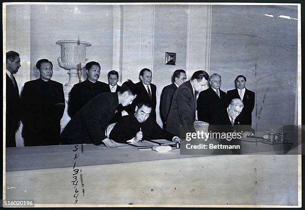 Moscow, Russia: Chou En-Lai and Mikolai Bulganin sign joint declaration at Kremlin Jan 18, 1957 which sets forth the Communist leadership's view of...