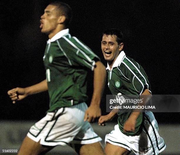 Chique Arce , defenseman for the team Palmeiras, celebrates his teammate Lopes' third goal against Cruzeiro in a qualifying match for the...