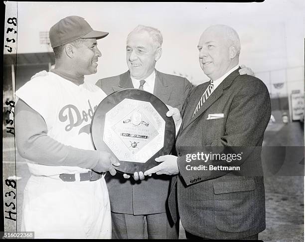 New York, NY: Brooklyn Dodgers catcher Roy Campanell, the National League's most valuable player for 1955 is shown here receiving his award from...