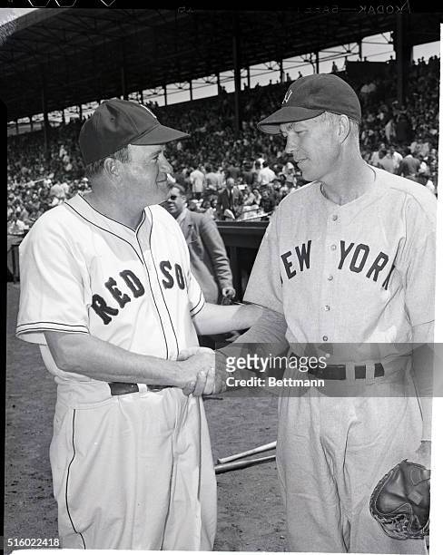 Boston, MA: Joe Cronin , pilot of the league leading Boston Red Sox, Congratulates Bill Dickey, new manager of the New York Yankees, before game in...