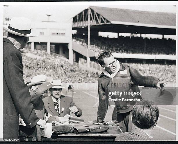 Melbourne, Australia- Chris Brasher of Great Britain argues with Olympic officials after being disqualified in the 3,000-meter steeplechase of the...