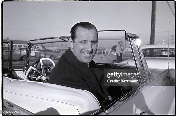 Los Angeles, CA: Hank Greenberg, general manager of the Cleveland Indians signifies "wait and see" as he arrives here supposedly to talk to former...