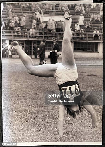 Helsinki, Finland- Dana Zatopek of Czechoslovakia hoops it up with a victory cartwheel after winning the woman's javelin throw at Helsinki, July,...