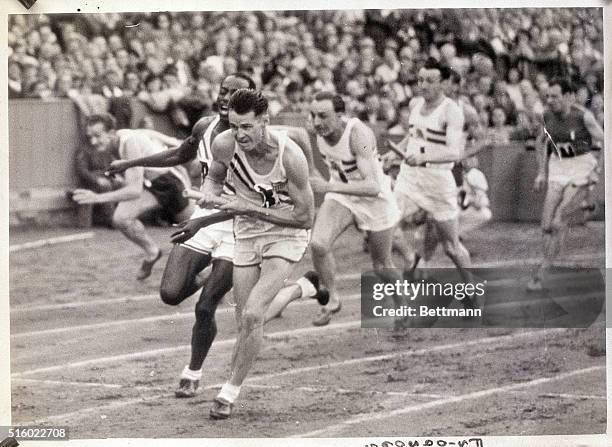 London, England- Picture shows H. Dillard handing over to M.E. Patton during the 400-meter final relay.