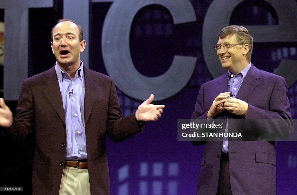 Amazon.com CEO Jeff Bezos (L) tells a joke with Mi