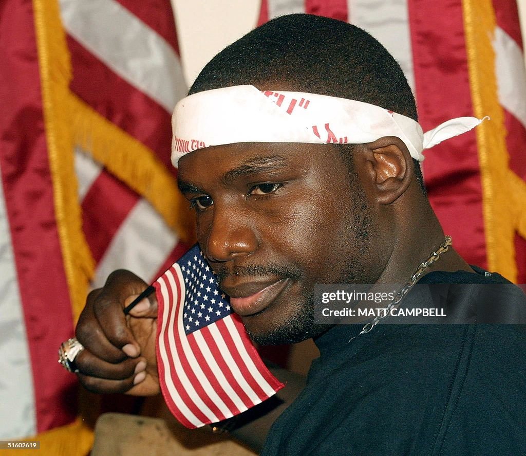Hasim R World Heavyweight Champion Hasim Rahman holds a US flag during a ...