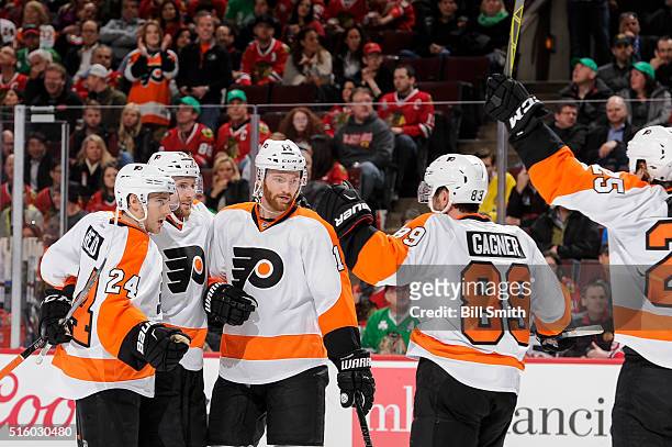 Andrew MacDonald of the Philadelphia Flyers celebrates with teammates, including Matt Read and Sean Couturier, after scoring in the first period of...