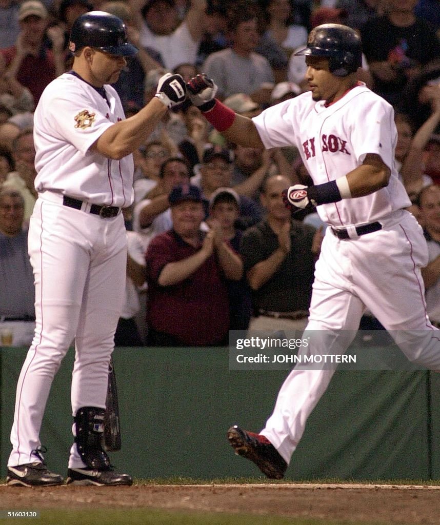 Manny Ramirez of the Boston Red Sox (R) is greeted