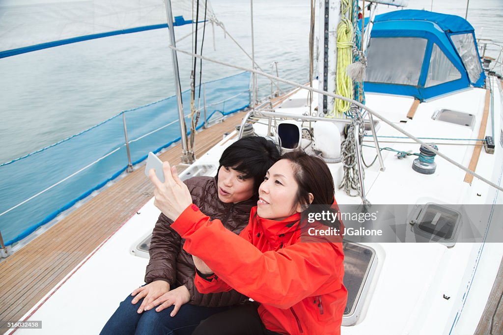 Two women on a luxury yacht taking a selfie