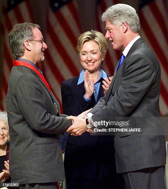 President Bill Clinton along with First Lady Hillary Rodham Clinton congratulates movie producer Steven Spielberg after awarding him with the 1999...