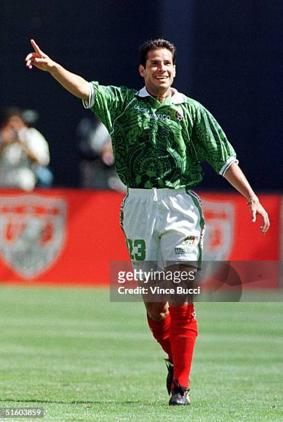 Jose Manuel Abundis of Mexico raises his hand after scoring a goal against Team USA during their Nike US Cup soccer match 13 March 1999 in San Diego,...